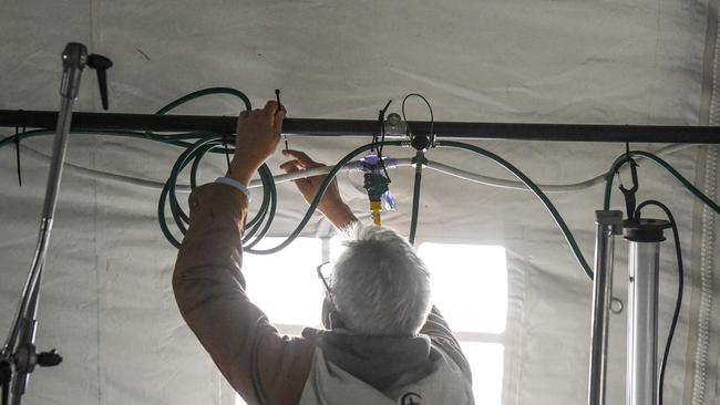 A person sets up power and oxygen lines in the Central Park emergency field hospital. Picture: Stephanie Keith/Getty Images/AFP