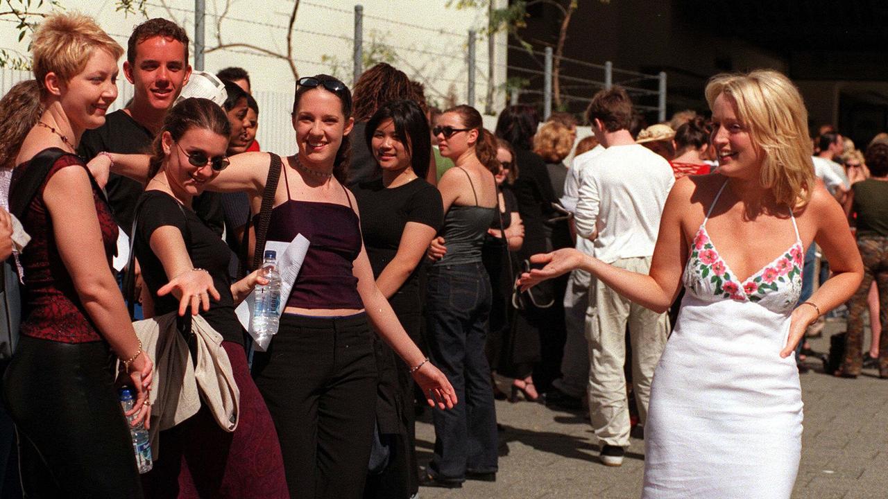 Is there a more 2000 image than Jackie O in a slip dress sauntering past a bunch of Popstars auditionees?