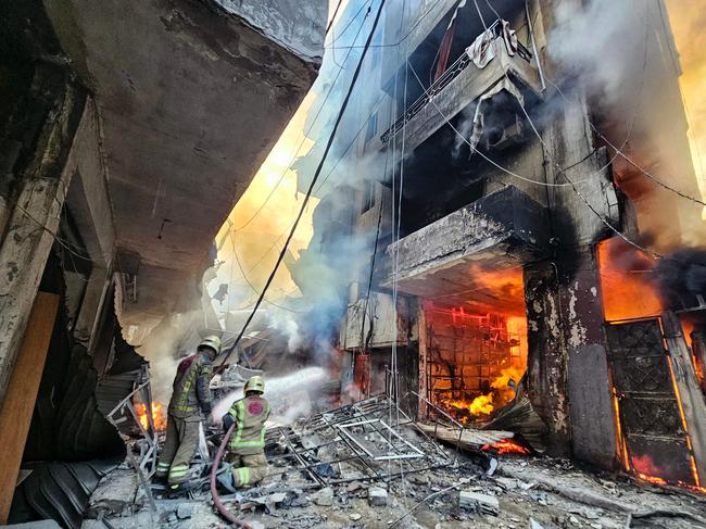 Firefighters in Beirut’s southern suburbs battle flames after a building was hit in an Israeli air strike in the Hadath neighbourhood. Picture: AFP