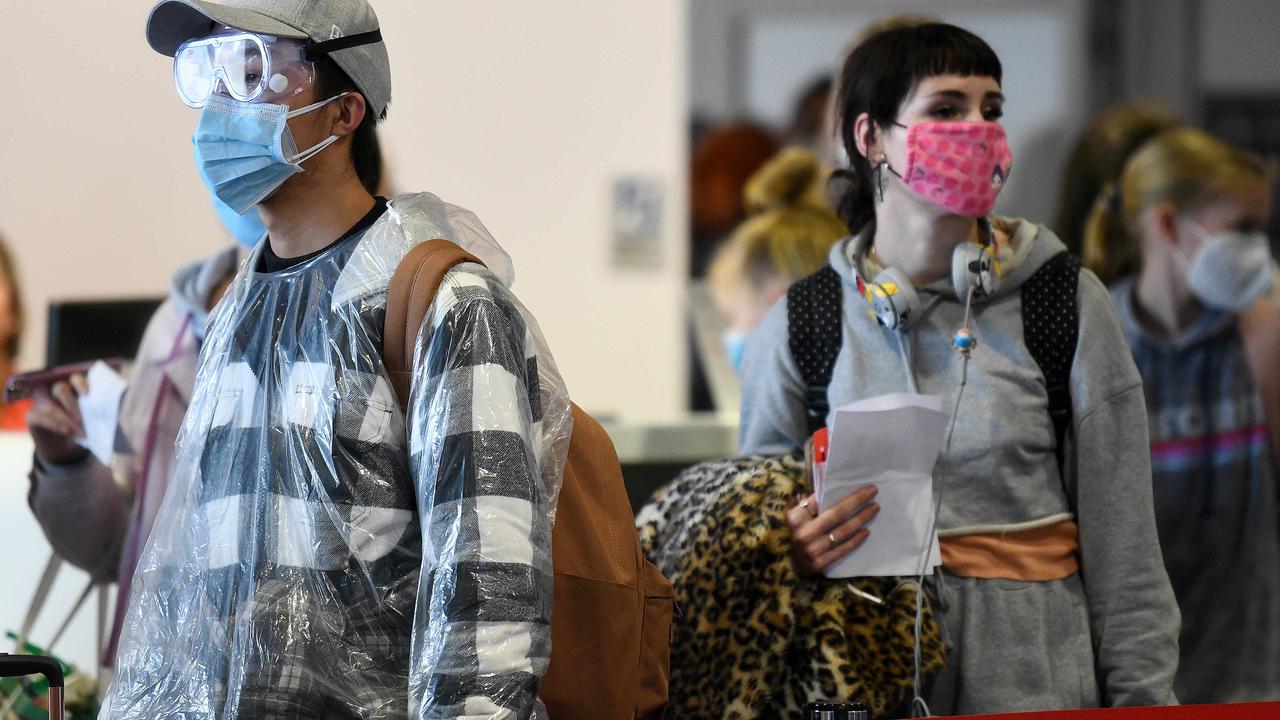 Passengers wearing face masks disembark a flight last week at Sydney Airport, where passengers from Melbourne aren’t tested on arrival. Picture: Bianca De Marchi/NewsWire