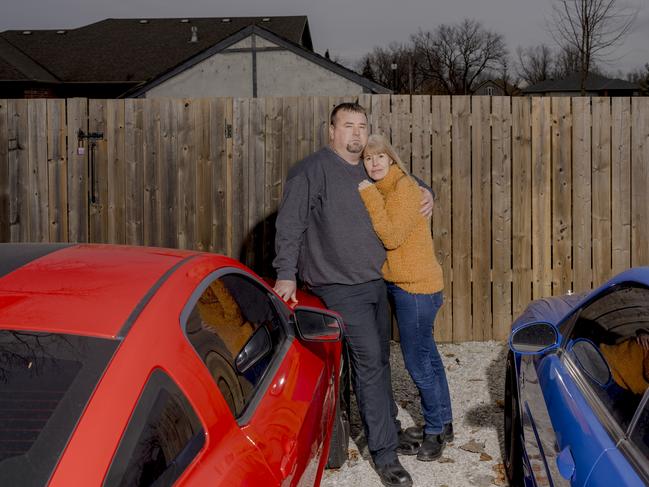 Chad Lawton, 50, left, and his wife, Krysten Lawton, 52, pose for a portrait outside of their home in LaSalle, Ontario, Canada on Feb. 5, 2025. The husband and wife both work for Ford Motor Company. Krysten works as a health and safety trainer and Chad works as a plant chairman for Unifor Local 200. (Nic Antaya for The Australian)