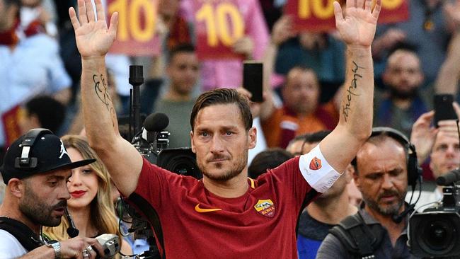 AS Roma's captain Francesco Totti greets fans during a ceremony.