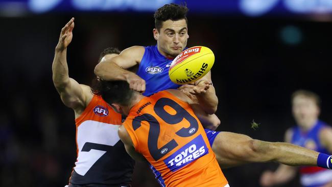 Luke Dahlhaus is crunched by Zac Williams in a tackle. Picture: Michael Klein