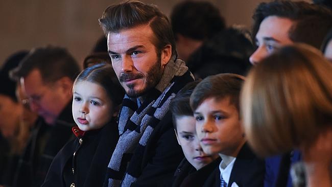 British soccer player David Beckham and his children attend his wife Victoria Beckham's show during the Fall 2016 New York Fashion Week.