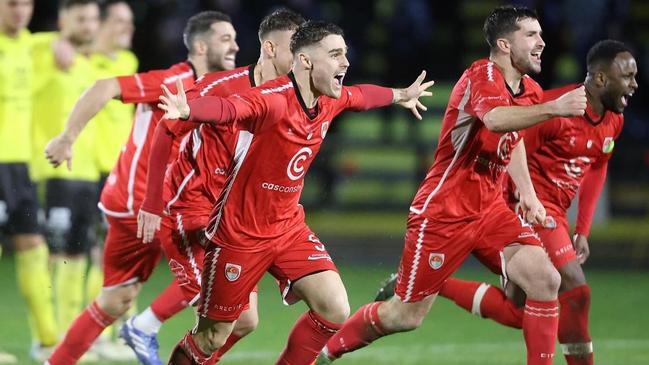 Hume City players celebrate their penalty shootout win. Picture: Teyfik Baser