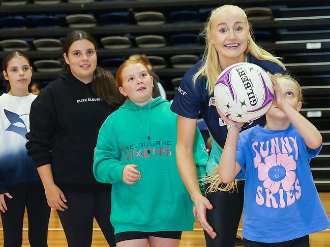 Launch of the 2024 Melbourne Fox Netball Season. Vixens player Jo Weston with junior girls on the court. Picture: Ian Currie