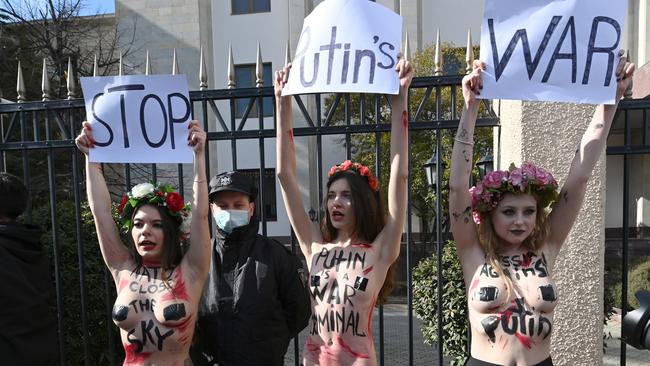 Activists hold placards during a rally in front of the former Russian embassy, in Tbilisi on March 12, 2022, to protest against the Russian invasion in Ukraine. Picture: Vano Shlamov/ AFP