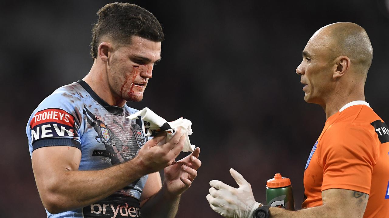 TOWNSVILLE, AUSTRALIA - JUNE 09: Nathan Cleary of the Blues is attended to by a team trainer after a cut to his face during game one of the 2021 State of Origin series between the New South Wales Blues and the Queensland Maroons at Queensland Country Bank Stadium on June 09, 2021 in Townsville, Australia. (Photo by Ian Hitchcock/Getty Images)