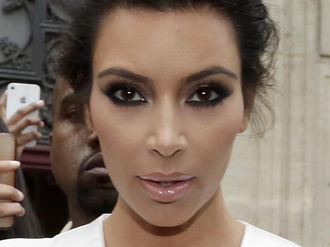 American reality TV star Kim Kardashian leaves her residence in Paris on May 23, 2014, ahead of their wedding. American singer Kanye West and his bride-to-be Kim Kardashian lunched on May 23 at a French chateau owned by iconic designer Valentino, kicking off a marathon celebration expected to culminate in the wedding of the year. AFP PHOTO / KENZO TRIBOUILLARD