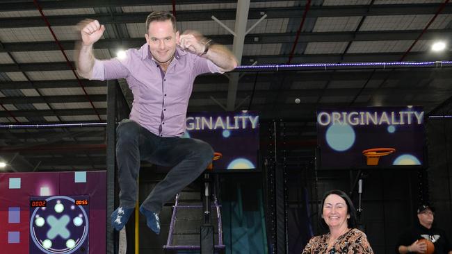 Logan councillor Jon Raven gets some height on the trampoline while councillor Teresa Lan watches on at Area 51, Underwood.