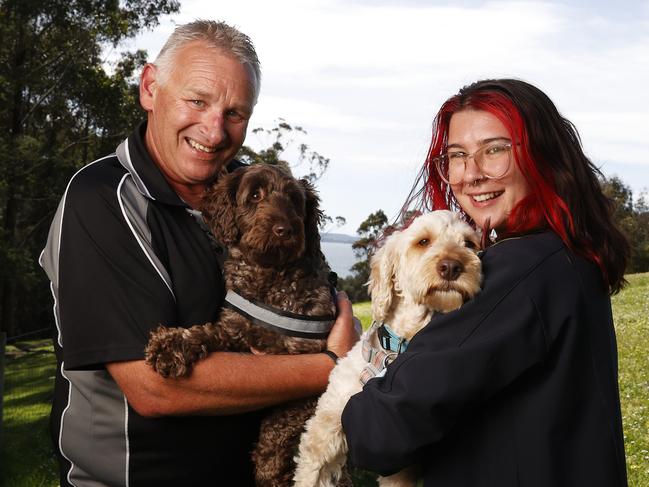 Mick Kelleher with Max who is 3 and Alex Zammitt with Bentley who is 4 with both being in care since August.  SUN TAS.  Labradoodle gathering at Suncoast Dog Park Blackmans Bay of some of the dogs rescued from the puppy farm shut down in Tasmania that have now been rehomed.  Picture: Nikki Davis-Jones