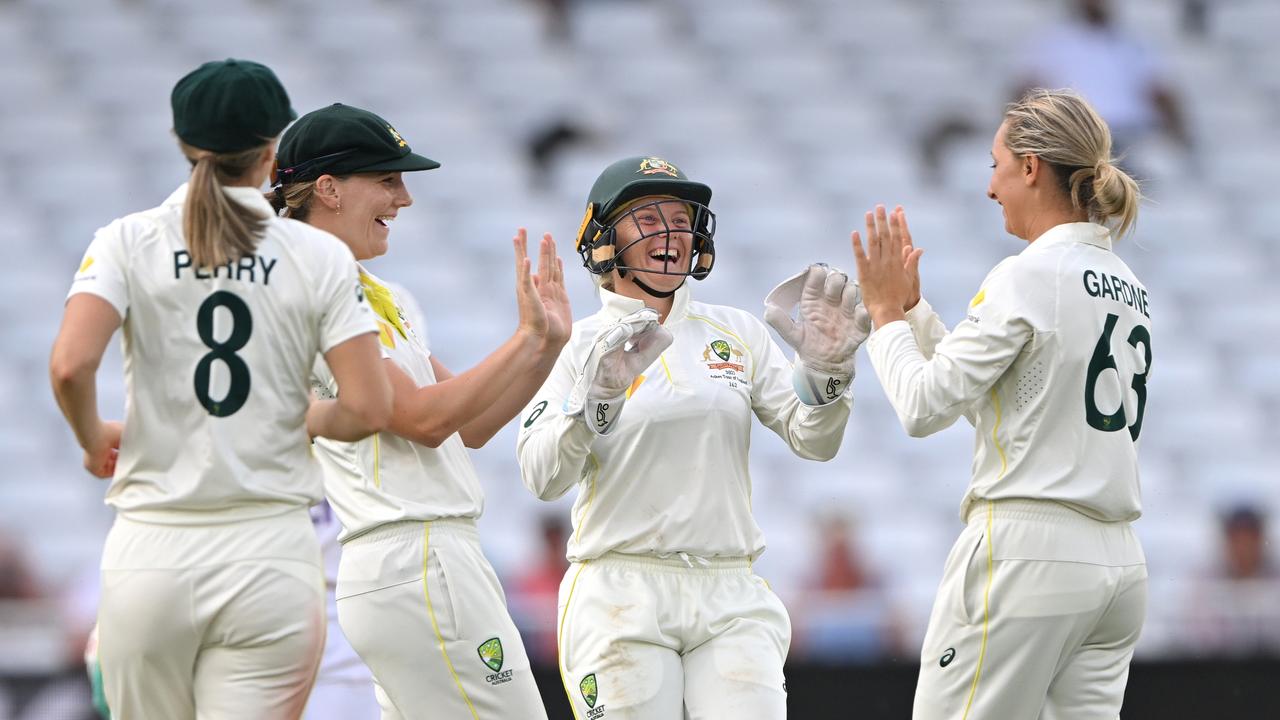 Australia captain Alyssa Healy (c) congratulates Ashleigh Gardner after taking the wicket of Tammy Beaumont during day four.