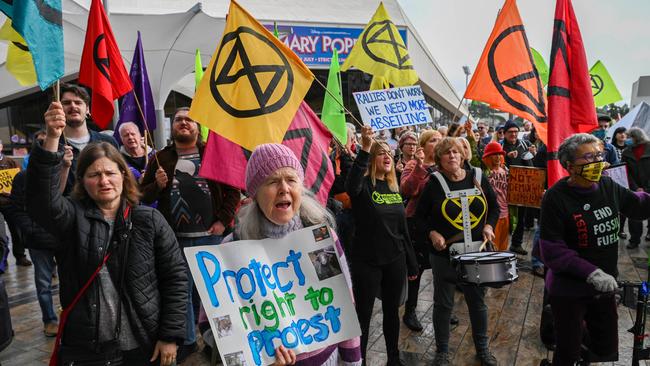 Extinction Rebellion members attempt to power a windmill with hot air. Picture: NCA NewsWire / Naomi Jellicoe