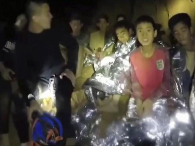 FILE - In this July 3, 2018, file image taken from video provided by the Thai Navy Seal, Thai boys are with Navy SEALs inside a cave in Mae Sai, northern Thailand. The day-to-day pearls of wisdom imparted by coaches to players _ from little league, to high school, to college and even the pros _ are rarely all that groundbreaking: Try your hardest, don't lose focus, support your teammates, keep your chin up. In the case of 12 youth soccer players trapped in a cave in Thailand, it helped save their lives. Unsure of their prospects for more than two weeks while they awaited rescue from a waterlogged cave, the group of kids and their coach found themselves in a life-and-death struggle that placed an acute focus on the value of teamwork, positive attitude and strong leadership. (Thai Navy Seal via AP, File)