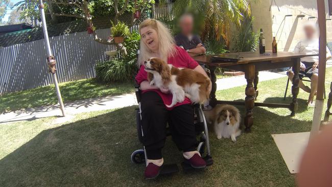 Ann Marie Smith, happy at a social occasion in 2011, with her dogs Maggie and Deana. Picture: SAPOL