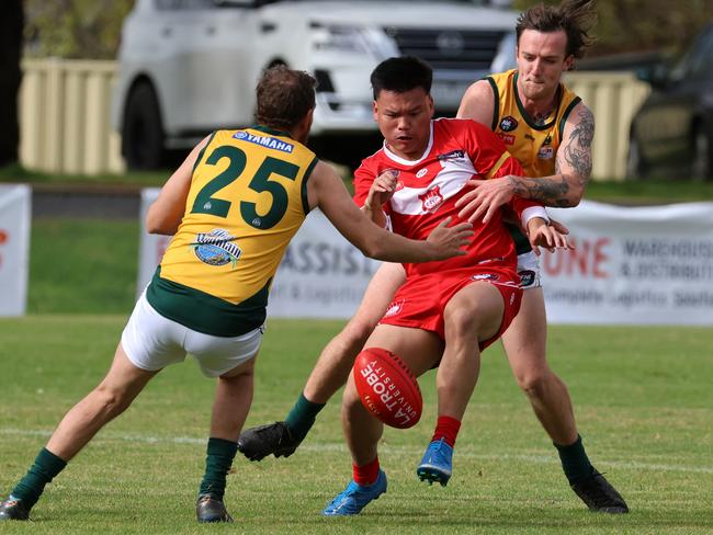 NFNL: Tim Hung Do tries to get a kick away for Lalor. Picture: Hamish Blair