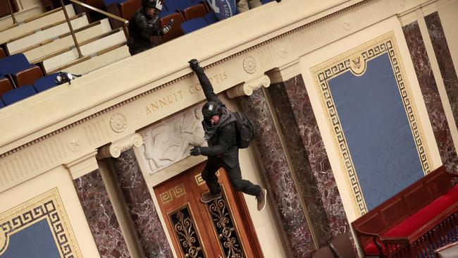 A protester is seen hanging from the balcony in the US Senate chamber last week. Picture: Win McNamee/Getty Images