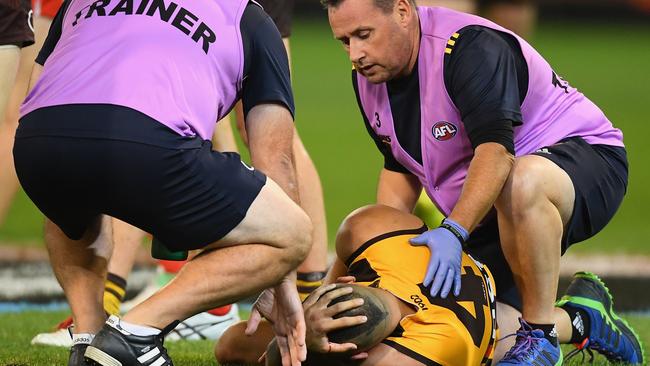 Jarman Impey is helped by Hawthorn trainers after the bump. Picture: Getty