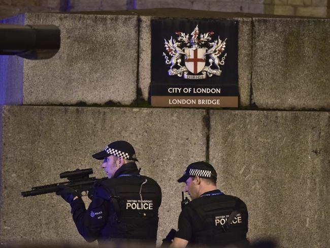 An armed Police officer looks through his weapon on London Bridge. Picture: Dominic Lipinski/PA via AP