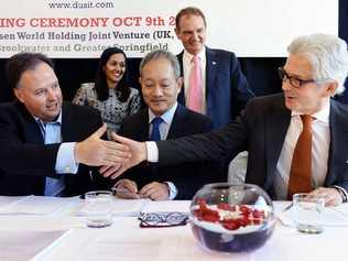 FUTURE PLANS: Brookwater Resort Investments CEO Richard Turner (left) shakes hands with Dusit Thani CEO David Shackleton while Maxsen Capital Hong Kong CEO Jimmy Chan (middle) looks on. Picture: Rob Williams