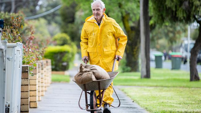 Rochester local Barry, 82, works to protect his house during October’s floods. Picture: Jason Edwards