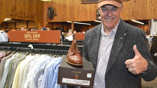 R.M Williams die hard Wayne Preedy with a pair of men's brown leather boots at the Toowoomba outlet sale on May 8, 2025. Photo: Jessica Klein