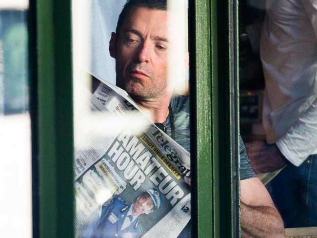 Hugh Jackman has breakfast with his family as he catches up on the news reading The Daily Telegraph. Picture: Media-mode.com