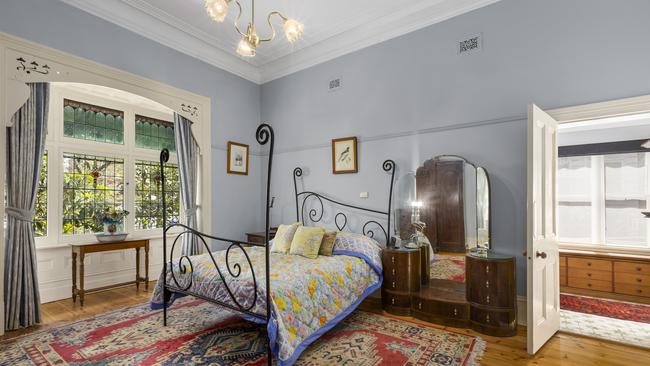 The grand main bedroom has another large bay window.