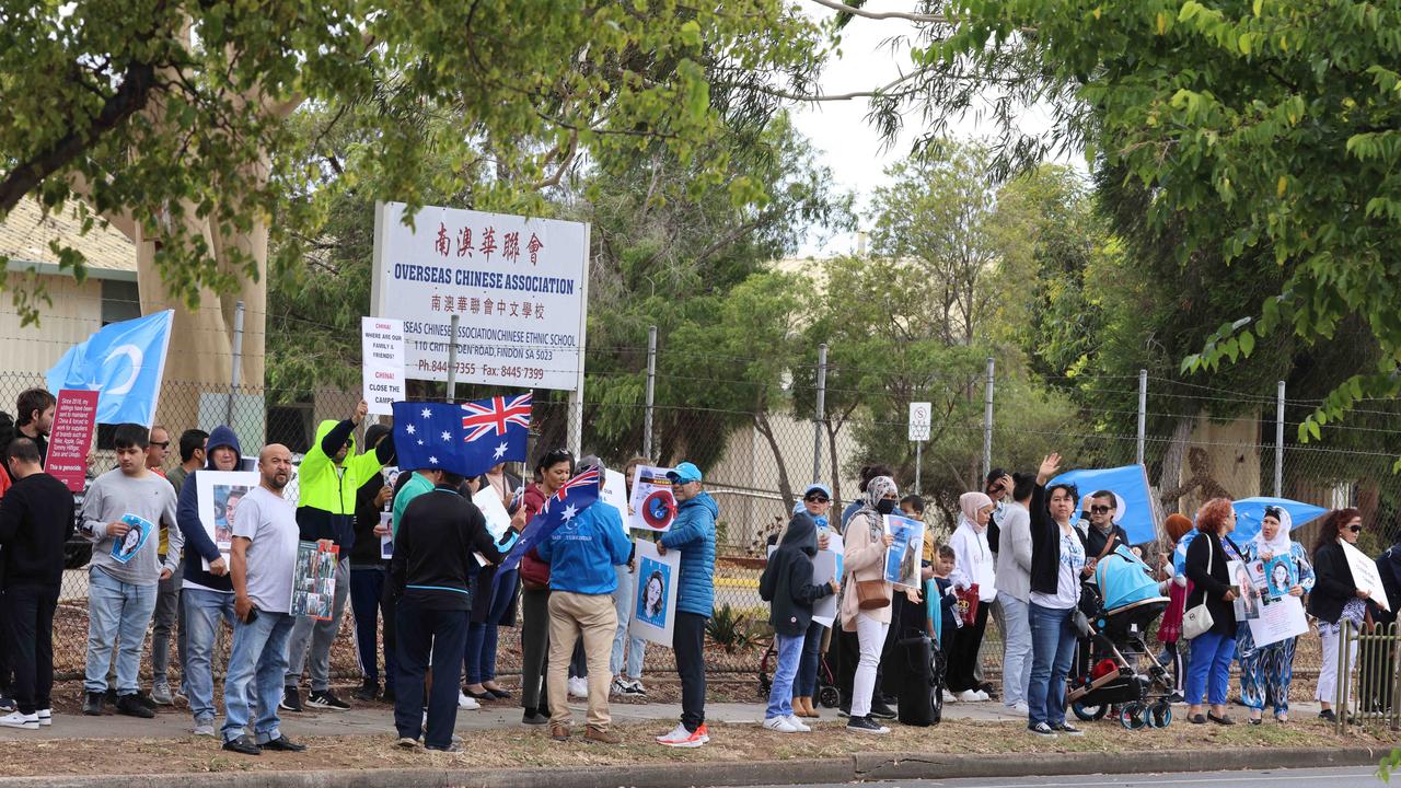 Protesters gather outside the Overseas Chinese Association building in Adelaide to protest the persecution of Uighurs. Picture: Russell Millard