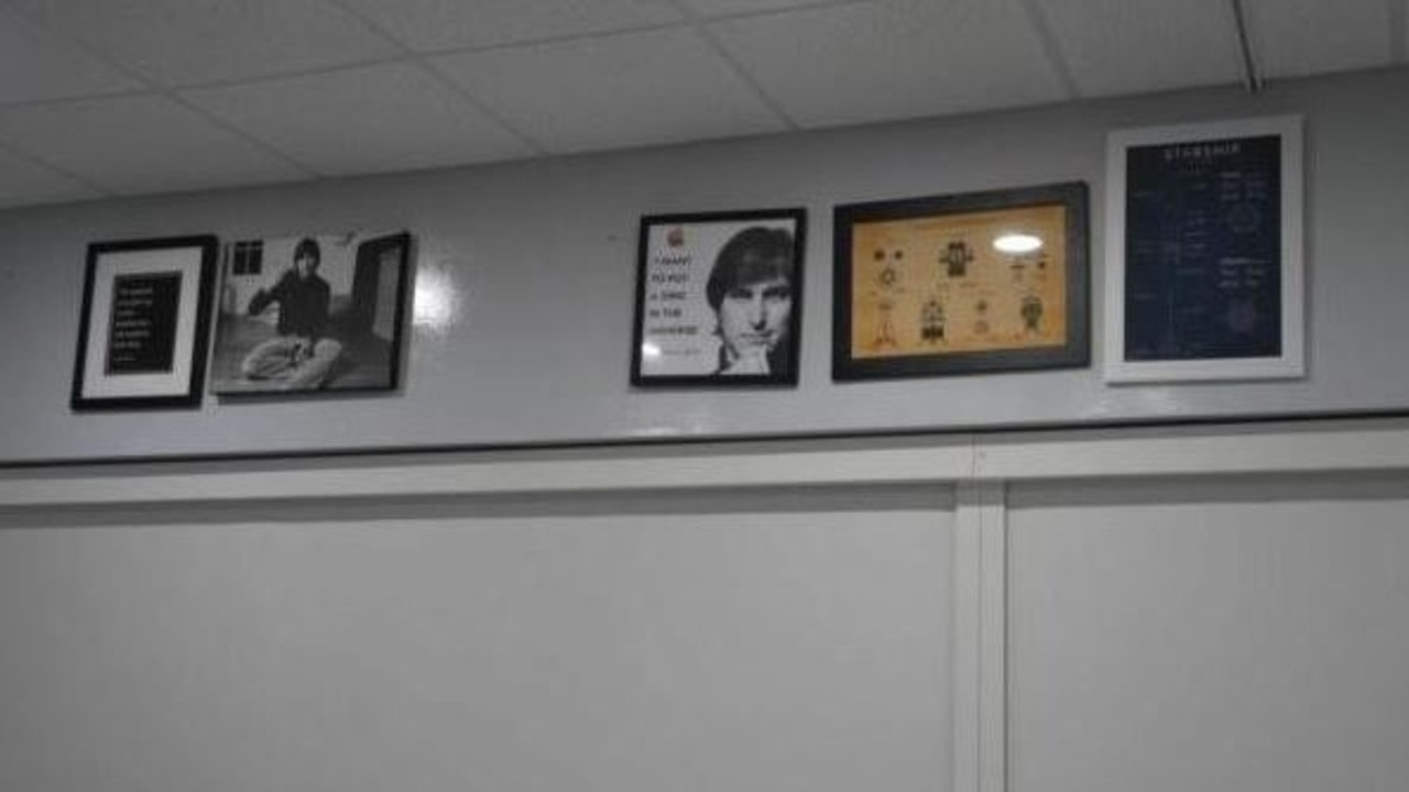 The framed photos of Apple founder Steve Jobs on the walls.