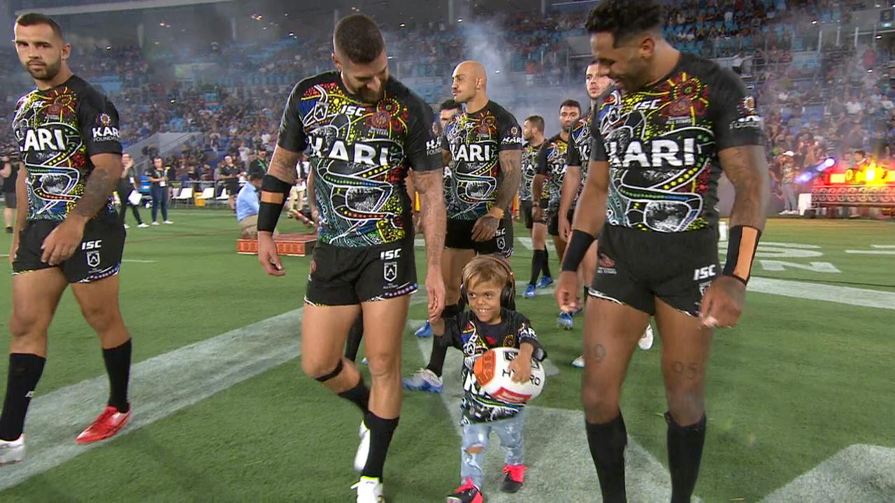 Nine-year-old bullying victim Quaden Bayles leads out the Indigenous All Stars team.