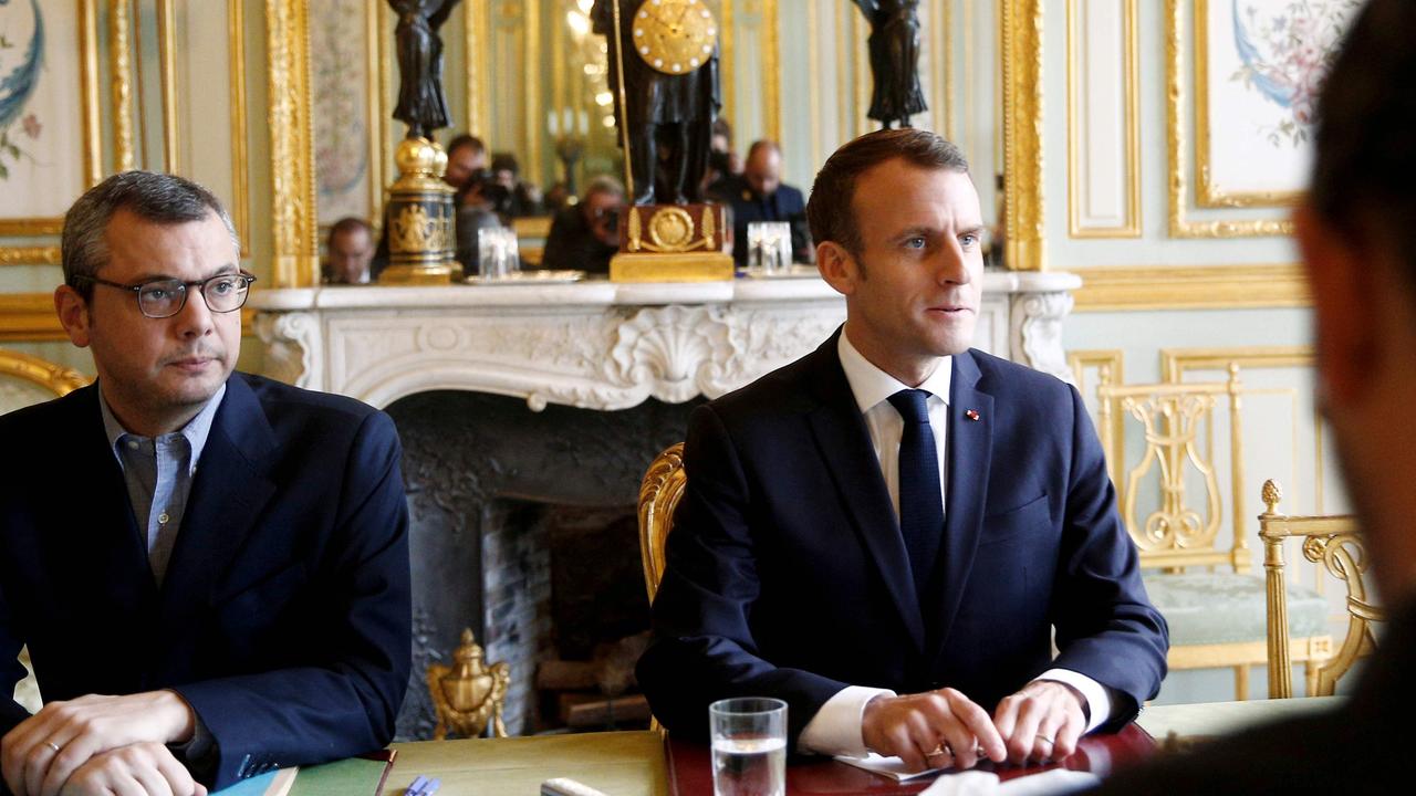 French President Emmanuel Macron (C) sits in front of French Prime Minister Edouard Philippe (back) during a meeting at the Elysee Palace in Paris. Picture: AFP