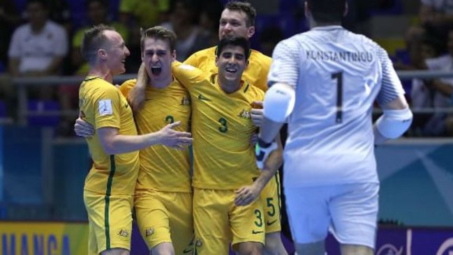 Futsalroos celebrate a goal.