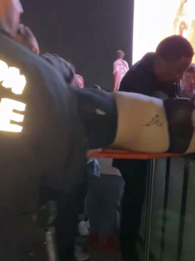 The woman is carried over the barricade … Picture: TMZ/Backgrid