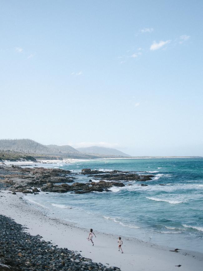 Jodi Wilson’s children frolic on a quiet Tasmanian beach. Picture: Jodi Wilson