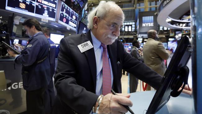 Trader Peter Tuchman, right, works on the floor of the New York Stock Exchange, Wednesday, Nov. 25, 2015. Stocks are drifting higher in early trading as markets start to wind down ahead of the Thanksgiving holiday in the U.S. (AP Photo/Richard Drew)