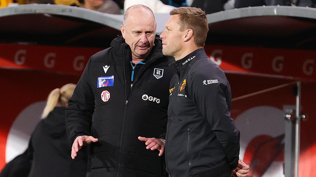 Ken Hinkley and Sam Mitchell, talk after the match. Photo by Sarah Reed/AFL Photos via Getty Images.