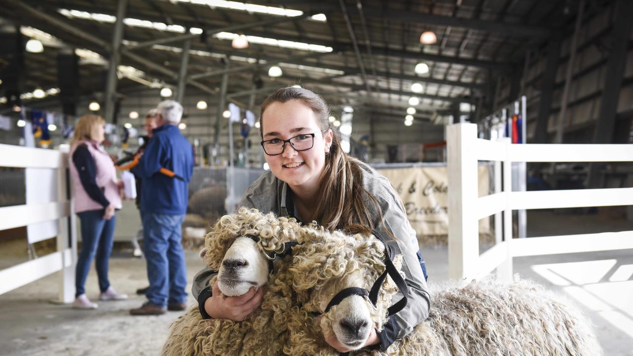 Emily Humphrey, 16, from Langwarrin, with two of Helen Raven’s Lincoln sheep on Sunday, September 22 at the Royal Melbourne Show. Photo: Dannika Bonser