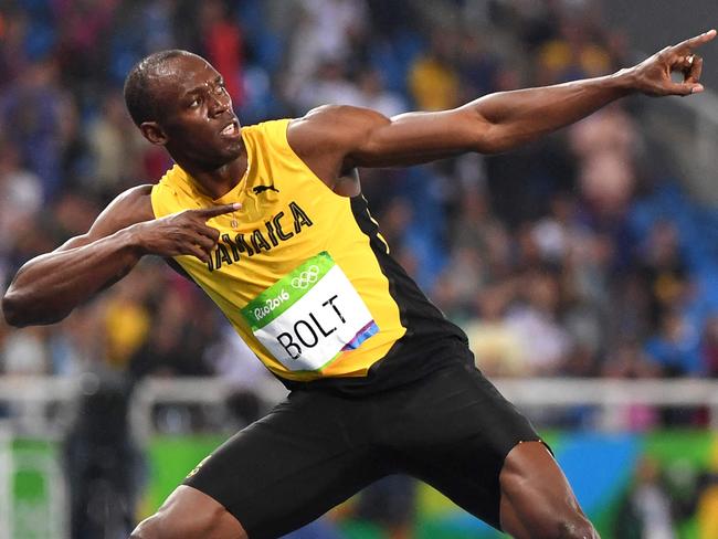 (FILES) Jamaica's Usain Bolt does his "Lightening Bolt"pose after he won the Men's 200m Final during the athletics event at the Rio 2016 Olympic Games at the Olympic Stadium in Rio de Janeiro on August 18, 2016. Jamaica's Usain Bol best-known as "Lightning Bolt" smashed the world records at the Beijing Games in 2008 for the 100m and 200m, going on to better his times a year later and making him to date the record holder in both. (Photo by OLIVIER MORIN / AFP)