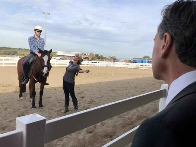 Federal Health Minister Greg Hunt watches a horse rider in action at the opening of the new $2 million South East Equestrian Club in Malabar on Friday, July 26.