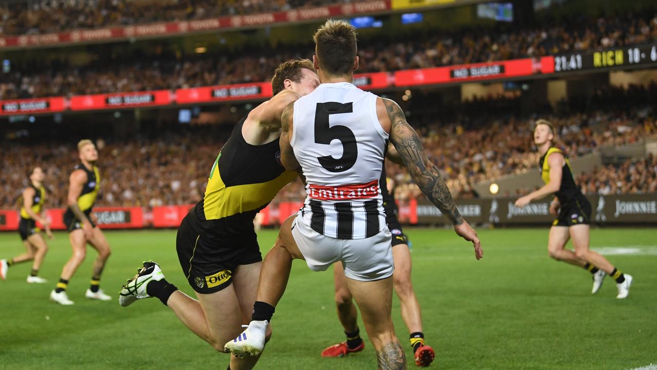 Dylan Grimes makes contact with Jamie Elliot. Photo: Julian Smith/AAP Image.