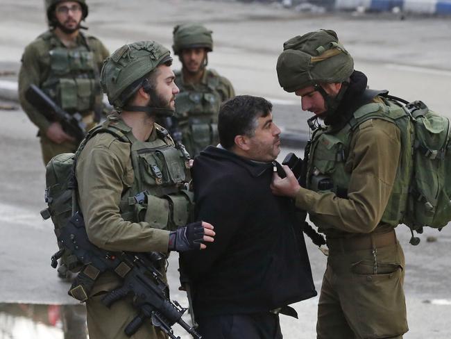 Israeli forces detain a Palestinian protester during clashes that followed protests in Hebron in the Israeli-occupied West Bank. Picture: AFP