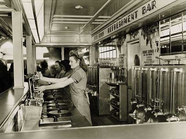 1946 a waitress works behind the milk bar inside Central Station. NSW State Records