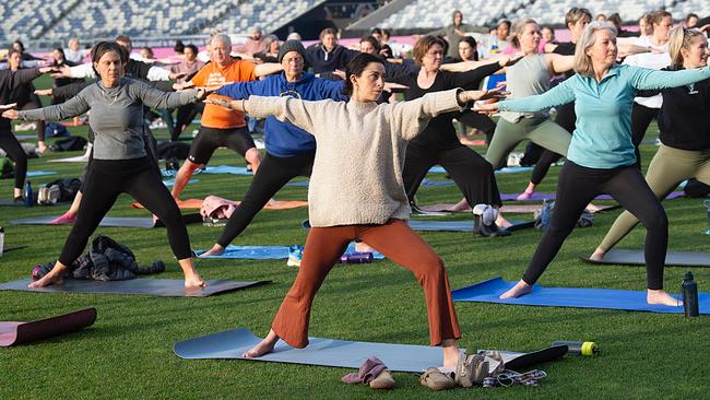 Around 250 people turned up to Kardinia Park at dawn to watch the sunrise during a yoga session for Serenity in the Stadium marking World Mental Health Day. Picture: Alan Barber