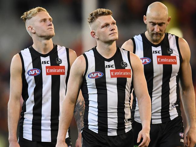 MELBOURNE, AUSTRALIA - SEPTEMBER 21: Jaidyn Stephenson, Adam Treloar and Ben Reid of the Magpies look dejected after losing the AFL Preliminary Final match between the Collingwood Magpies and the Greater Western Sydney Giants at the Melbourne Cricket Ground on September 21, 2019 in Melbourne, Australia. (Photo by Quinn Rooney/Getty Images)