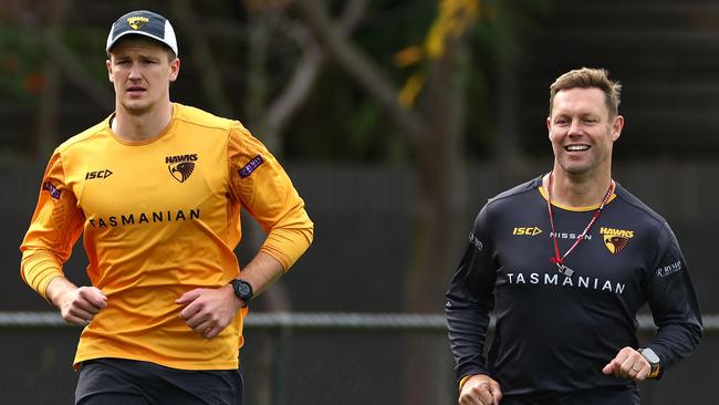 Hawks coach Sam Mitchell runs laps with key forward Mitch Lewis (left) at Waverley Park, as Lewis tries to return from a knee injury which flared following a hamstring strain he suffered in round 2. Picture: Quinn Rooney / Getty Images