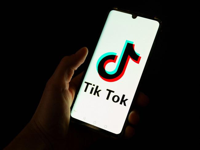 (FILES) This photograph taken on April 19, 2024 shows a man holding a smartphone displaying the logo of Chinese social media platform Tiktok in an office in Paris. TikTok faces an imminent shutdown in the United States after Congress passed a law last year forcing its Chinses owner ByteDance to either sell the platform or close it by this January 19, 2025. The US Supreme Court is expected to rule this week on TikTok's challenge to the law. (Photo by Antonin UTZ / AFP)