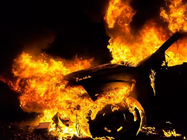 Car in fire, burning at night