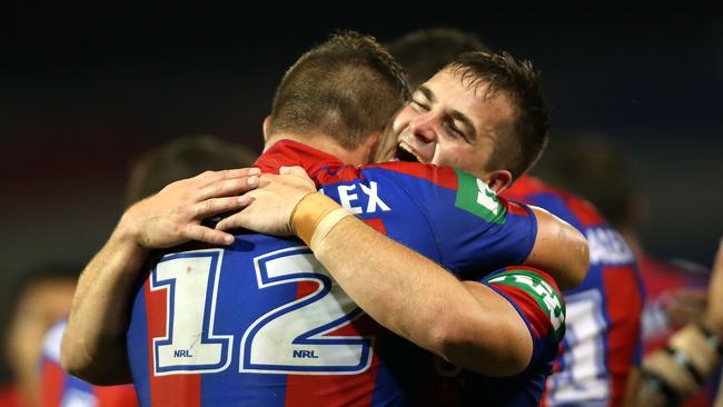 Chad Redman celebrates a try with Knights teammate Tariq Sims on NRL debut. Picture: Getty Images