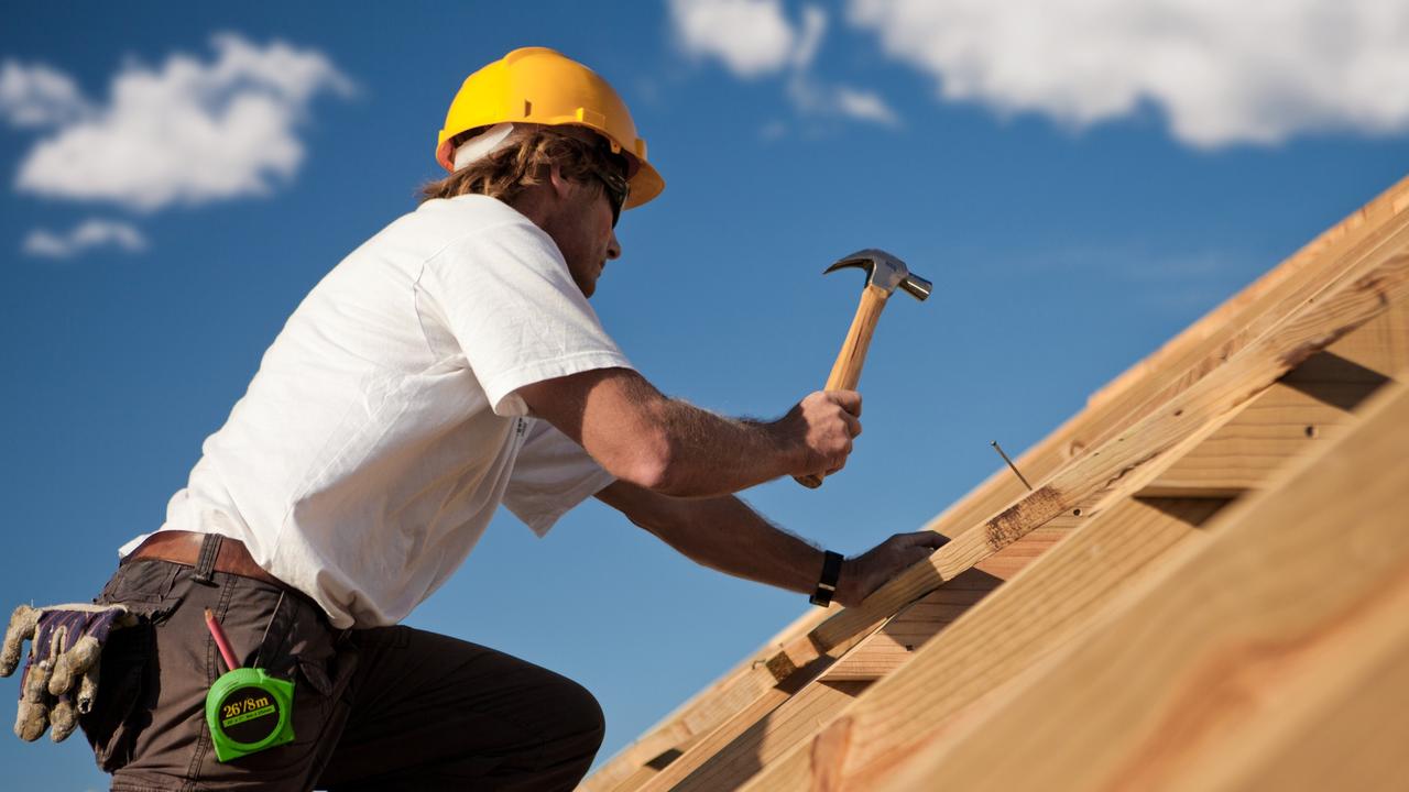 worker on a roof with hammer, generic tradesman